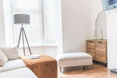 a living room with a couch and a ottoman at Luxury townhouse in Workington in Workington