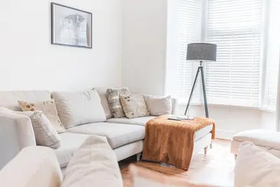 a white living room with a couch and a table at Luxury townhouse in Workington in Workington