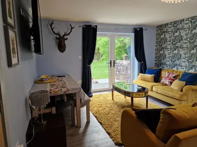 a living room with a table and a couch at The Den by Blake View Holidays a peaceful boutique retreat 3 miles from Ennerdale- standard twin or super-king bed available in Rowrah