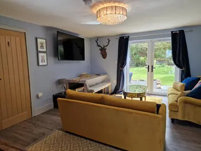 a living room with a couch and a table at The Den by Blake View Holidays a peaceful boutique retreat 3 miles from Ennerdale- standard twin or super-king bed available in Rowrah