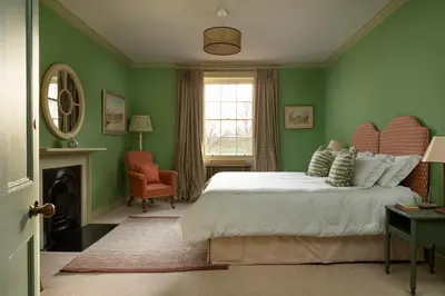 a green bedroom with a bed and a chair at Dabton House in Carronbridge