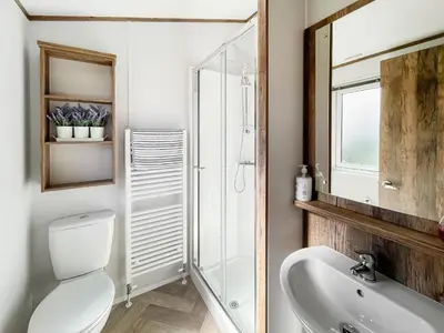 a bathroom with a toilet and a sink and a mirror at Bud's Bay in Mainsriddle