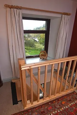 a room with a window and a wooden staircase at Helvellyn Room With View - Double or twin in Penrith