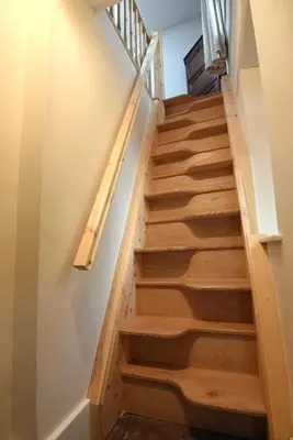 a staircase with wooden steps in a house at Helvellyn Room With View - Double or twin in Penrith