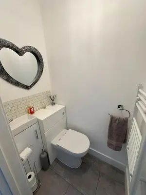 a bathroom with a white toilet and a mirror at Chapel Terrace - 2 Bedrooms - Sleeps 4 in Cleator Moor