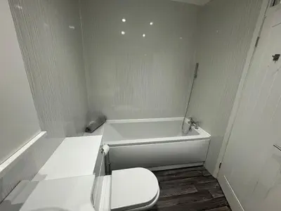 a white bathroom with a toilet and a tub at Chapel Terrace - 2 Bedrooms - Sleeps 4 in Cleator Moor