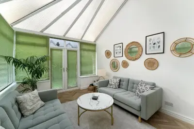 a living room with a couch and a table at Mansefield, Keswick - Sleeps 6 in Keswick