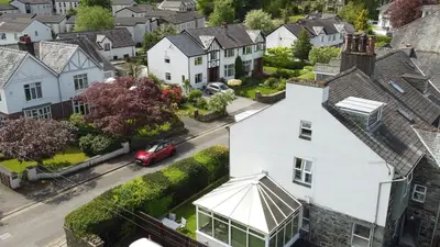 an aerial view of a white house in a residential neighborhood at Mansefield, Keswick - Sleeps 6 in Keswick