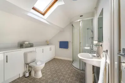 a bathroom with a toilet and a sink and a shower at Mansefield, Keswick - Sleeps 6 in Keswick