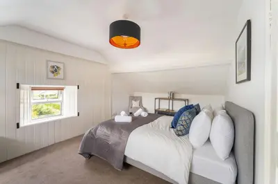 a bedroom with a bed and a window at Mansefield, Keswick - Sleeps 6 in Keswick