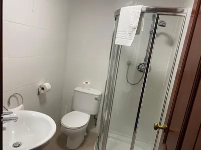 a bathroom with a shower and a toilet and a sink at townhouse apartments in Ayr