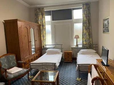 a hotel room with two beds and a window at townhouse apartments in Ayr
