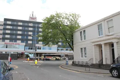 a city street with a bus in front of a building at townhouse apartments in Ayr