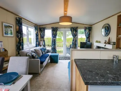 a kitchen and living room with a couch at Plot 41 in Carlisle
