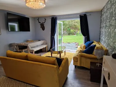 a living room with two couches and a table at The Stables by Blake View Holidays, comprising The Nest, The Drey, The Burrow and the Den, 3 miles from Ennerdale in Rowrah