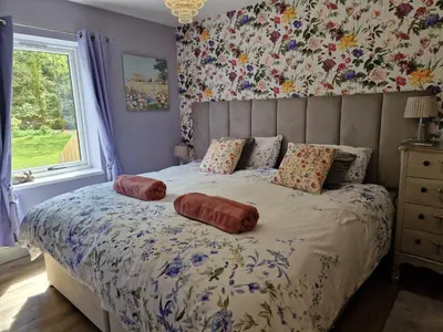 a bedroom with a bed with pillows on it at The Stables by Blake View Holidays, comprising The Nest, The Drey, The Burrow and the Den, 3 miles from Ennerdale in Rowrah