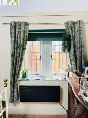 a window with a radiator in front of a window at Dinmont Cottage in Dalston