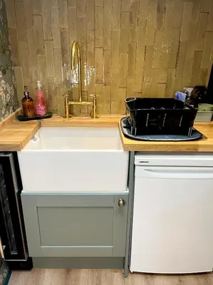 a kitchen sink with a tray on top of it at Dinmont Cottage in Dalston