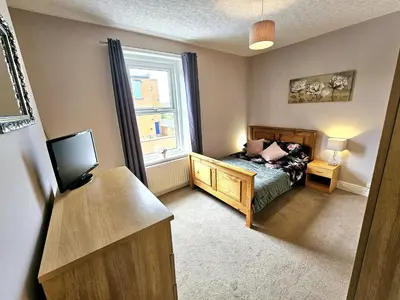 a small bedroom with a bed and a window at Ashley House, Carlisle in Carlisle