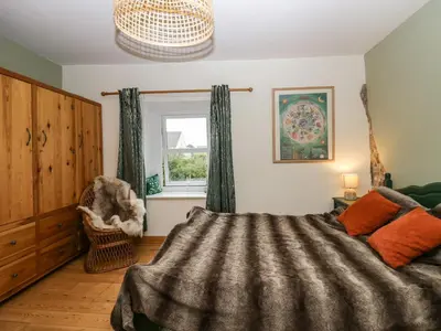 a bedroom with a bed and a window at Whitecroft Nook in Seascale