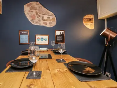 a table with plates and wine glasses on it at Whitecroft Nook in Seascale