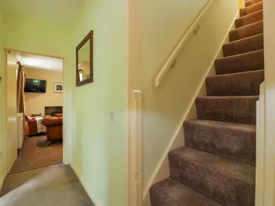 a staircase in a home with a stair case at Kilnmark Farmhouse in Thornhill