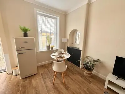 a room with a small table and a refrigerator at Prestwick KingB PetsOk FreeP Wifi Tv in Prestwick