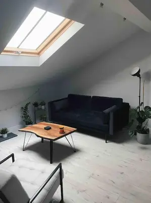 a living room with a blue couch and a coffee table at Lakes Loft in Cockermouth
