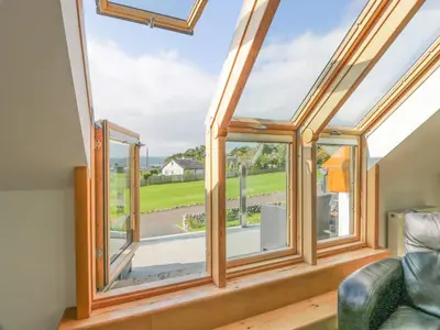 an image of a room with a conservatory with windows at Seascape in Dalbeattie