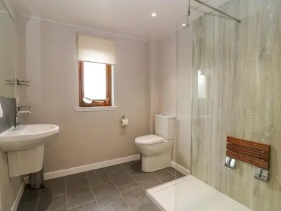 a bathroom with a toilet and a sink and a shower at Seascape in Dalbeattie