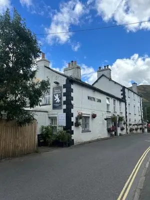 a white building on the side of a street at The White Lion Inn in Penrith