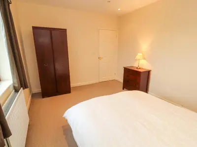 a bedroom with a bed and a lamp on a dresser at Valley View in Cleator Moor