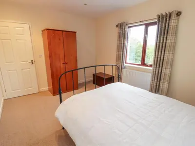 a bedroom with a bed and a window at Valley View in Cleator Moor