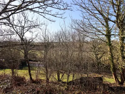 a field with trees and a bridge in the distance at Valley View in Cleator Moor