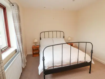 a bedroom with a bed and a window at Valley View in Cleator Moor