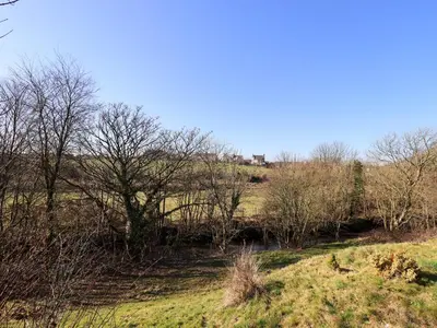 a view of a field with trees and a river at Valley View in Cleator Moor