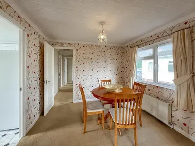 a dining room with a table and chairs at Tredegar in Newton Stewart
