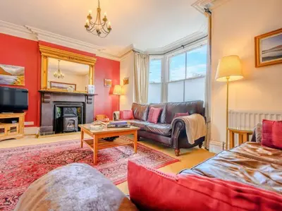 a living room with a couch and a tv at The Gables in Keswick