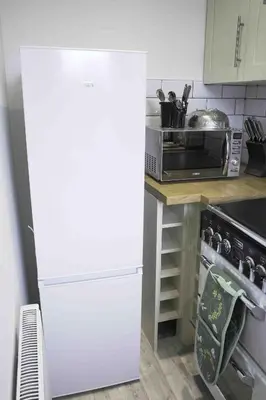 a kitchen with a white refrigerator and a microwave at Strath Apartment in Strathaven