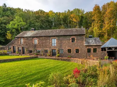 an old stone house with a large lawn at Bank Barn, Wreay in Penrith