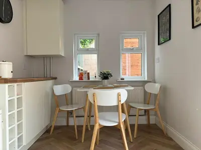 a kitchen with a table and chairs in a room at Cosy Cumbrian home away from home in Whitehaven