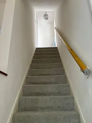 a staircase in a building with a stair case at Cosy Cumbrian home away from home in Whitehaven