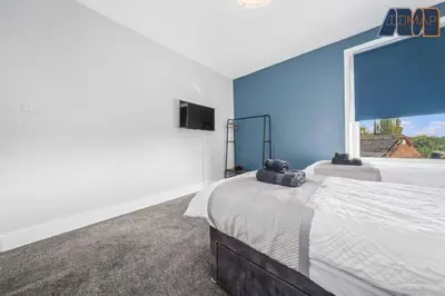 a bedroom with a bed and a large window at Carlisle 3Bed Sleeps 6 in Carlisle
