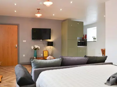 a living room with a couch and a flat screen tv at Haaf Netters Rest - Uk43557 in Bowness-on-Solway
