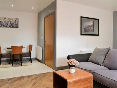 a living room with a couch and a table at Haaf Netters Rest - Uk43557 in Bowness-on-Solway