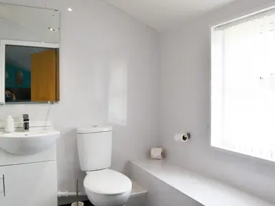 a white bathroom with a toilet and a sink at John Collingwood Bruce Suite - Uk43558 in Bowness-on-Solway