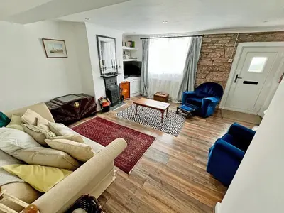 a living room with a couch and a fireplace at Coast To Coast Cottage in Cleator Moor