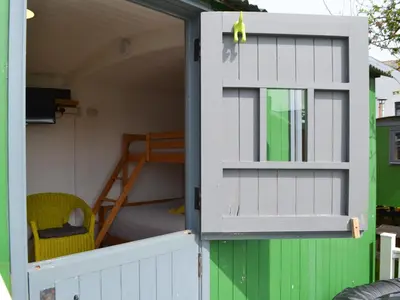 ajar door of a play house with a bunk bed at Ryan's Shepherd Hut - Uk43565 in Bowness-on-Solway