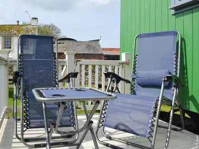 a pair of chairs and a table on a patio at Jamie's Shepherds Hut - Uk43566 in Bowness-on-Solway
