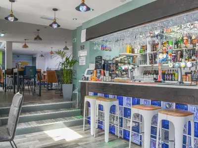 a bar in a restaurant with stools at Jamie's Shepherds Hut - Uk43566 in Bowness-on-Solway